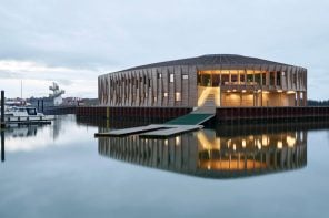 This circular community center for water sports clubs in Denmark references maritime construction